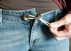 a person is holding two scissors in their pocket and pulling them apart from the jeans