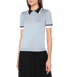 Prada looks to sporting silhouettes this season, adding a subversive slant to shirting staples such as this collared polo shirt. Crafted in the brand's native Italy from a lightweight silk knit, it's rendered in a pale blue colorway trimmed with black and white edges. Tuck yours into a pleated midi skirt for a preppy finish..Made in Italy.Closure: partially buttoned front.Material: 100% silk.Care instructions: dry clean.True to size.Designed for a loose fit.Lightweight material.Falls to the hip. Spring Cotton Polo Shirt With Contrast Collar, Blue Collared Polo Sweater For Workwear, Spring Polo Shirt With Striped Collar, Spring Polo Shirt With Striped Collar And Short Sleeves, Summer Workwear Polo Shirt With Ribbed Collar, Summer Polo Sweater With Ribbed Collar For Work, Summer Workwear Polo Sweater With Ribbed Collar, Short Sleeve Polo Sweater With Ribbed Collar For Spring, Blue Polo Shirt With Striped Collar For Work