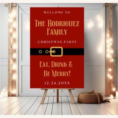 a christmas party sign sitting on top of a wooden easel