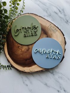 two wooden signs sitting on top of a tree stump