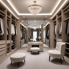 a walk in closet with two chairs and a foot stool