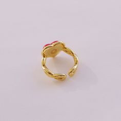 Made from delicate porcelain, this ring features a vibrant red heart-shaped centrepiece that captures the essence of love and romance. The rich, deep red hue adds a touch of warmth and passion, making it a perfect accessory for any occasion. The heart is encased in a 18K gold-plated setting and a braided band.   MATERIAL Handmade porcelain  18K Gold-plated brass    SIZE & FIT Ring size: EU 54/US 7 Ring diameter: 17. 2mm Product size: 14mm x22mmx25mm  COLOUR Red, gold  WEIGHT 6g   Handmade in Den Round Enamel Ring For Valentine's Day Gift, Valentine's Day Gift Enamel Ring, Red Enamel Elegant Rings, Red Adjustable Heart Ring For Valentine's Day, Adjustable Red Heart Ring For Valentine's Day, Red Heart Ring For Valentine's Day, Elegant Red Enamel Ring, Red Enamel Ring For Gift, Red Enamel Rings For Gift