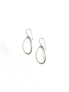 These simple wire teardrop earrings are perfect for every day. Handmade in the US and available in black steel, bronze, or silver. The classic design makes them perfect to throw on with everything - I've worn them as often with yoga clothes to run errands as I have with statement pieces like the Maya necklace. Available in steel with silver ear wires, steel with 14-kt gold-filled ear wires, sterling silver, or bronze with 14-kt gold-filled ear wires. Each earring is approximately 1 1/2" long. Comes packaged in a gift box - the perfect treat for yourself or a loved one! Black Steel, Yoga Clothes, Teardrop Earrings, Ear Wires, Statement Pieces, Classic Design, Gold Filled, Hoop Earrings, Yoga