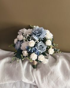 a bridal bouquet sitting on top of a bed