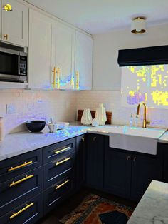 a kitchen with blue cabinets and white counter tops