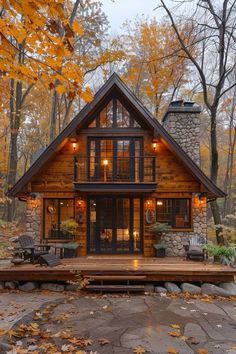 a small log cabin in the woods surrounded by fall foliage and trees with yellow leaves