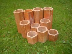 several pieces of wood sitting in the grass near each other on top of one another