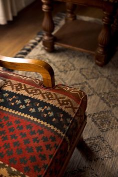 an old wooden chair sitting on top of a rug