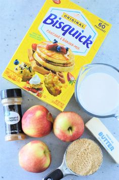 ingredients to make pancakes laid out on a table next to a bag of biscuits