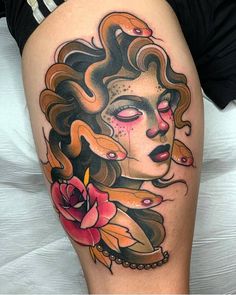 a woman's thigh with an artistic tattoo on it