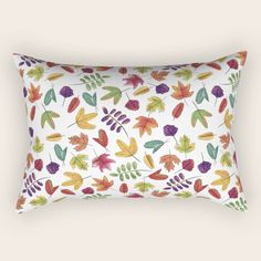 a white pillow with colorful leaves on it