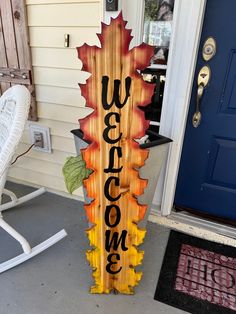 a wooden sign that says wisconsin on it in front of a blue door and white rocking chair