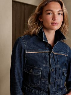 A timeless treasure to travel the world, this sturdy denim jacket is made from a sumptuous blend of new and organic cotton, with vegan leather piping at the seams and pockets for added pop.  WARM: Unlined and perfect for layering.  FROM ITALY'S CANDI Fall Cotton Denim Jacket With Contrast Stitching, Fall Denim Blue Outerwear With Contrast Stitching, Denim Blue Outerwear With Contrast Stitching For Fall, Fitted Denim Outerwear With Contrast Stitching, Fitted Denim Jacket With Contrast Stitching And Long Sleeves, Fitted Denim Jacket With Contrast Stitching, Classic Denim Jacket With Contrast Stitching, Denim Blue Jacket With Contrast Stitching For Fall, Dark Wash Denim Jacket With Contrast Stitching