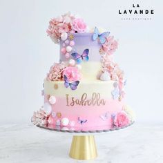 a multi layer cake decorated with flowers and butterflies