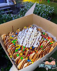 a box filled with hot dogs covered in toppings and marshmallows on top