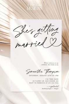 a wedding card with the words she's getting married written on it, next to a fan