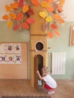 a tall clock tower with leaves on it