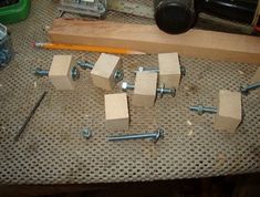 several pieces of wood sitting on top of a table next to screws and nuts