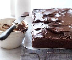 a cake with chocolate frosting and a bowl of ice cream