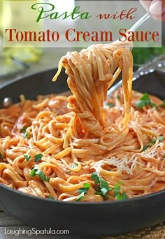 pasta with tomato cream sauce in a skillet being held up by a ladle