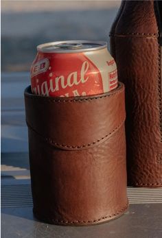 two brown leather can holders sitting next to each other