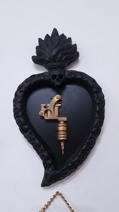 a heart shaped object with a key attached to it