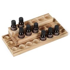 a wooden tray with nine bottles on it