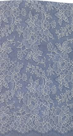 a blue lace with white flowers on it