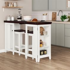 a kitchen island with two stools in the middle and shelves on both sides to store food