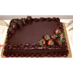 a large chocolate cake with strawberries on top