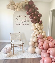 a little pumpkin is on the way balloon arch and chair for baby's first birthday