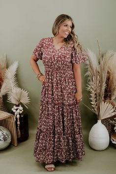 We are adoring the delicate floral pattern on this dress that makes it stand apart from the rest. Our Many Moments Floral Maxi Dress features a v-neckline, elastic waistband, cap flutter sleeves, and a three tiered design skirt. A true essential that transitions flawlessly throughout the seasons! Neckline: V-neckline Fabric: 100% Polyester Details: Lined, Elastic waistband, delicate floral print, tiered skirt Imported Fit: True to size; relaxed fit- Arms: Relaxed flutter sleeve- Chest: Relaxed- Modest V-neck Floral Print Dress, Fall Floral Print Short Sleeve Dresses, Modest Flowy Rayon Dress, Brown V-neck Dress For Garden Party, Flowy Floral Print Dress For Fall, Brown Floral Print V-neck Dress, Brown Short Sleeve Dress With Floral Print, Flowy Short Sleeve Maxi Dress For Fall, Brown Printed Flowy Dress