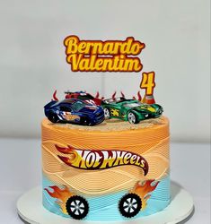 a birthday cake with two cars on top and the number 4 in the middle is for bernardo valentine's day