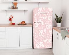 a pink refrigerator freezer sitting in a kitchen