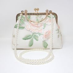 New to our Millennium collection, This beautiful romantic WHITE Embroidered LACE FLORAL bridal clutch bag is made of very fine quality of fabric and metal and it comes with a two long Detachable chain one is pearl chain and other is metal chain of your choice for your Big day! Dimensions- length oh the bag is 6.5 inches and width of the bag is 9 inches. Pearl chain measure about 43 inches and Gold Metal chain about 47 inches long. ► ABOUT YOUR ORDER * All items are neatly packaged in our beautiful jewelry boxes and elegant organza bags. * All items are 100% gift-ready. * Each order comes with a personalized handwritten card and a branded Millennium Bride jewelry cloth. * Each order comes with a free gift. ► PERSONALIZTION * If your order is a gift, you may contact us with the recipient's n Wedding Clutch Bridal, White Cross Body Bag, Bride Purse, Beaded Gloves, Bridal Clutch Bag, Bride Bag, Bridal Handbags, Bridal Purse, Wedding Clutch