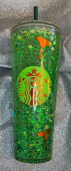 the starbucks cup is covered in green glitter