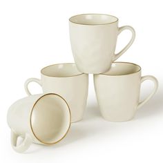 five white cups and saucers stacked on top of each other