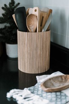 wooden utensils and spoons in a basket on a counter