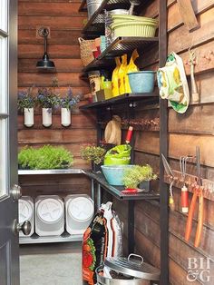 an outdoor kitchen with lots of pots and pans on the shelves next to it