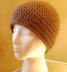 a mannequin head wearing a brown knitted hat