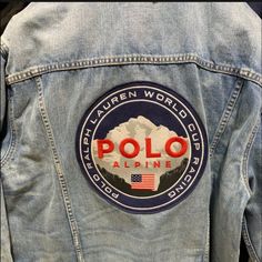 Polo Ralph Lauren Alpine World Cup Racing Denim Trucker Jean Jacket Size Xl Nwt. Limited Edition Size Xl New With Tags Sourced From A Storied American Mill, The Hardy 13.25-Oz. Denim Used In This Jacket Delivers Timeless Rugged Style That's Quintessential Polo Ralph Lauren. Adjustable Buttoned Tabs At The Back Of The Waist American-Made Shanks Buttoned Placket Imported Long Sleeves With Buttoned Barrel Cuffs Point Collar Signature Shank Closures Two Chest Buttoned Pockets Two Front Waist Welt Po Casual Outdoor Outerwear With Logo Patch, Casual Outerwear With Logo Patch, Casual Blue Outerwear With Logo Patch, Casual Long Sleeve Denim Jacket With Logo Patch, Casual Fitted Outerwear With Embroidered Logo, Denim Long Sleeve Outerwear With Logo Patch, Luxury Vintage Men's Denim Jacket, Luxury Blue Ralph Lauren Outerwear, Vintage Ralph Lauren Denim Jacket