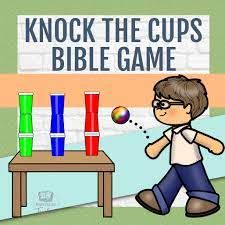 an image of a cartoon boy playing with some cups and a game on the table