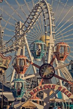 an amusement park ferris wheel with many rides