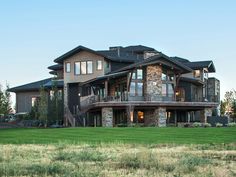 a large house sitting on top of a lush green field