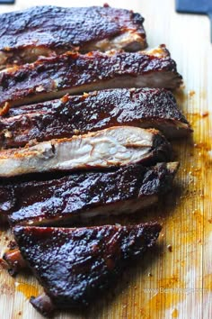 barbecue ribs on a cutting board with text overlay that reads electric smoker baby back ribs