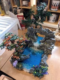 a table with some legos on it and trees in the middle one is made out of bricks