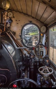 the inside of an old train car with mirrors and gauges on it's side