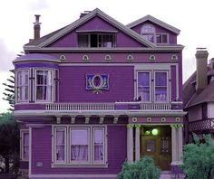 a purple house with white trim on the front and side windows is pictured in this image