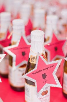 several bottles of wine on a table with pink and silver stars in the shape of star