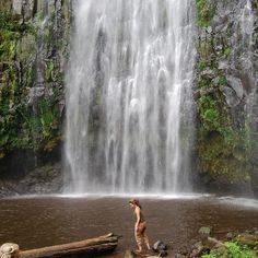 a person standing in front of a waterfall